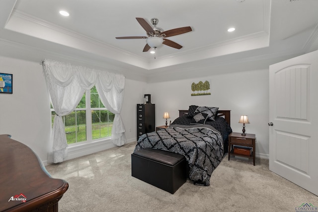 bedroom featuring ceiling fan, a raised ceiling, and ornamental molding