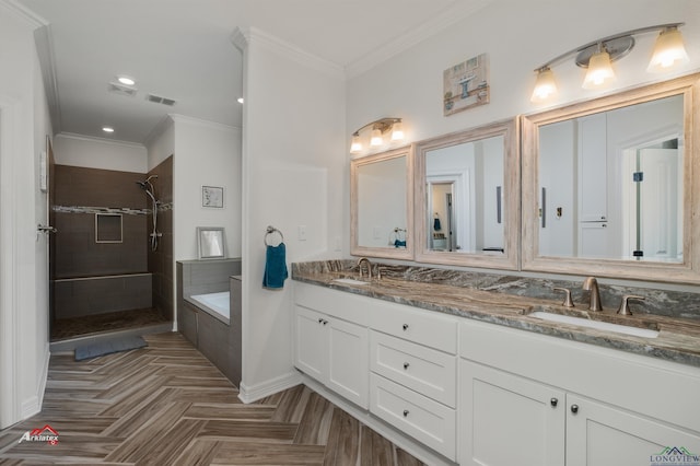 bathroom with vanity, parquet floors, ornamental molding, and shower with separate bathtub