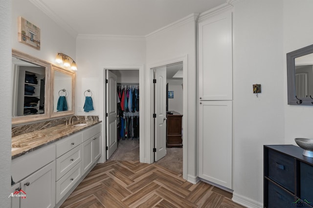 bathroom with vanity, crown molding, and parquet floors