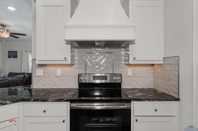 kitchen with backsplash, electric stove, white cabinets, and custom exhaust hood