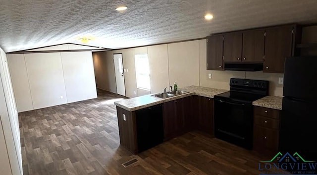 kitchen with dark brown cabinets, under cabinet range hood, dark wood-style floors, black appliances, and a sink