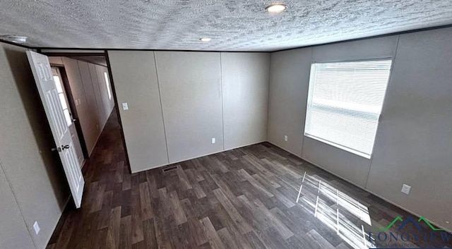 unfurnished bedroom featuring wood finished floors and a textured ceiling