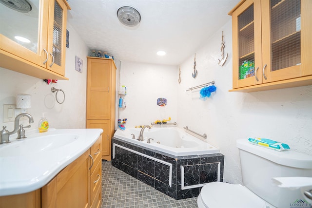 8123 Cherokee Trce, Gilmer, TX 75644 - bathroom featuring a jetted tub, vanity, and tile patterned flooring