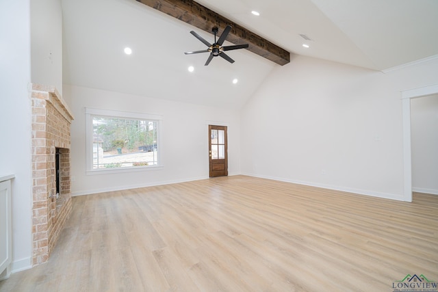 unfurnished living room featuring high vaulted ceiling, a brick fireplace, light hardwood / wood-style flooring, ceiling fan, and beam ceiling