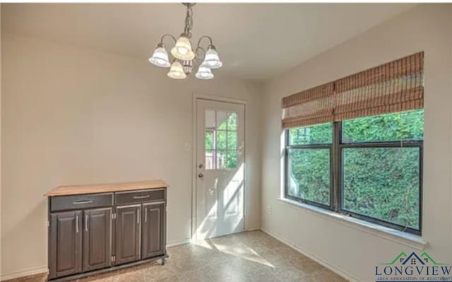 entryway featuring an inviting chandelier