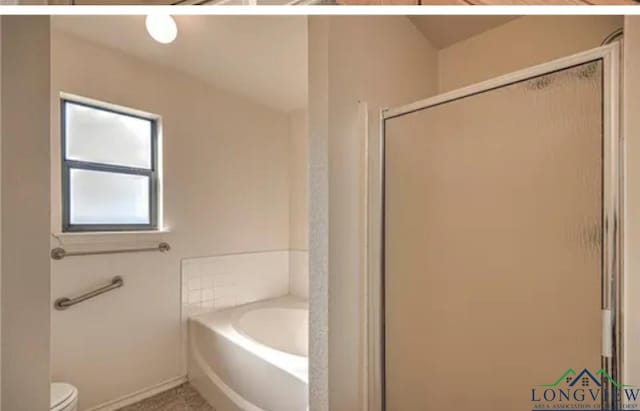 bathroom featuring toilet and plus walk in shower