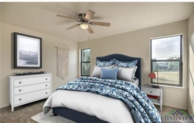 bedroom featuring ceiling fan and dark carpet