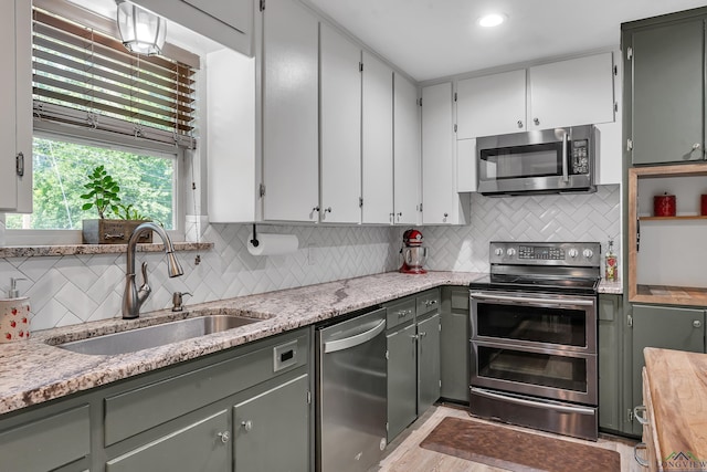 1907 Mary Jane Dr, Longview, TX 75601 - kitchen featuring appliances with stainless steel finishes and tasteful backsplash