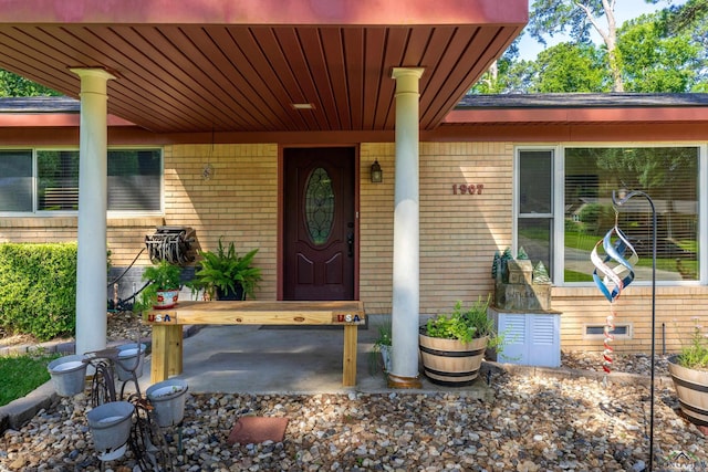 1907 Mary Jane Dr, Longview, TX 75601 - doorway to property with brick siding and a porch