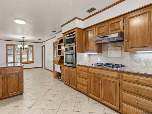 kitchen with stainless steel appliances, light stone countertops, pendant lighting, and light tile patterned floors