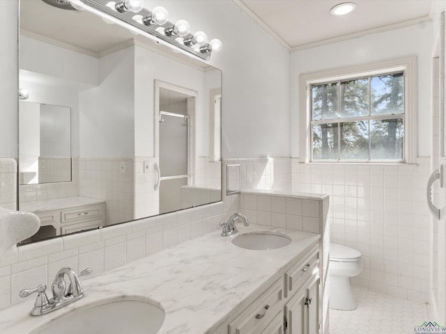 bathroom with tile walls, ornamental molding, vanity, toilet, and tile patterned floors