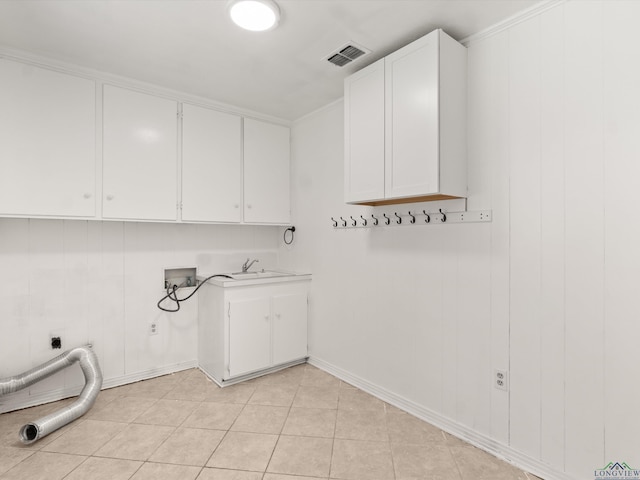 washroom with sink, hookup for a washing machine, cabinets, light tile patterned flooring, and hookup for an electric dryer