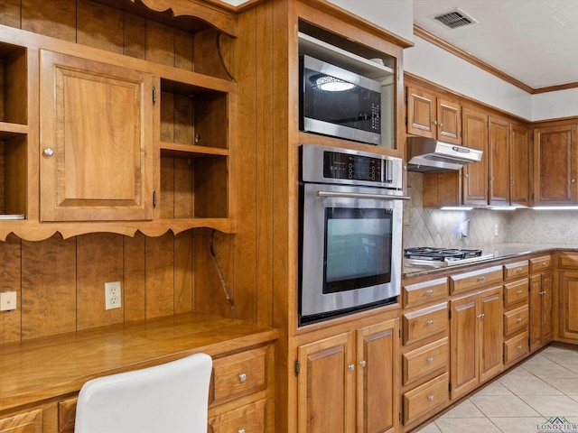 kitchen featuring stainless steel appliances, crown molding, light tile patterned floors, and decorative backsplash