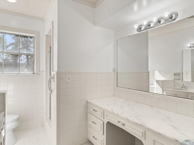 bathroom featuring crown molding, tile walls, vanity, tile patterned floors, and toilet