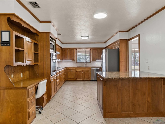 kitchen with light tile patterned flooring, appliances with stainless steel finishes, stone countertops, sink, and kitchen peninsula