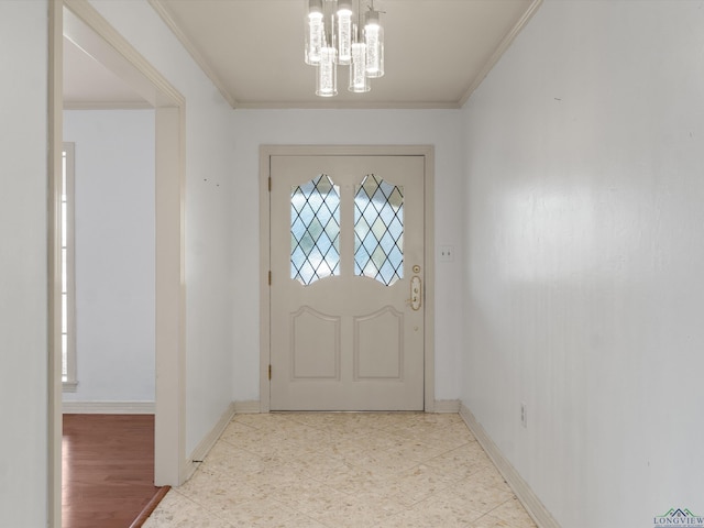 entryway with ornamental molding and a chandelier