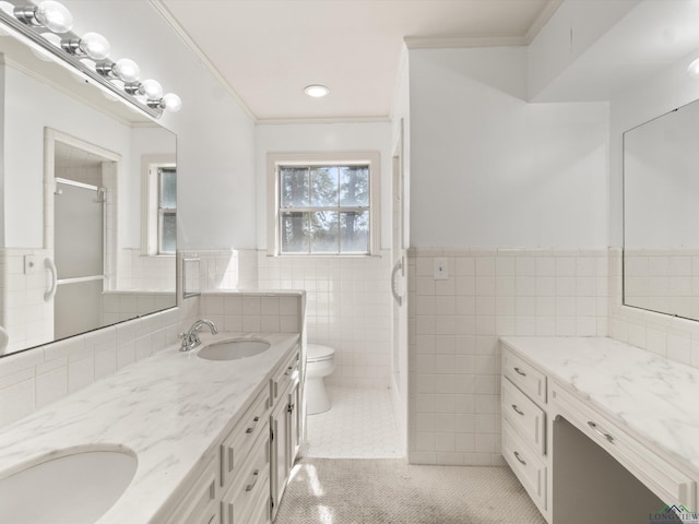 bathroom featuring toilet, crown molding, tile walls, vanity, and tile patterned flooring