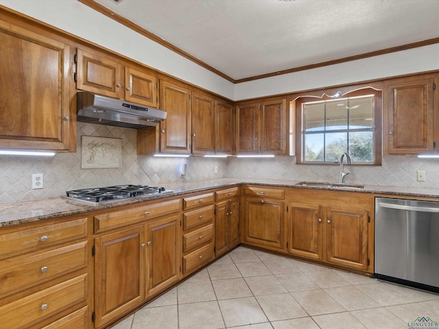 kitchen featuring sink, tasteful backsplash, ornamental molding, stainless steel appliances, and light stone countertops