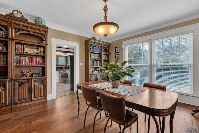 dining room featuring ornamental molding and hardwood / wood-style floors