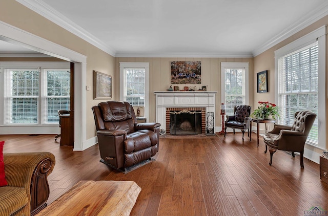 sitting room featuring crown molding, a fireplace, and hardwood / wood-style flooring