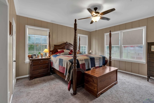 carpeted bedroom with ceiling fan and ornamental molding