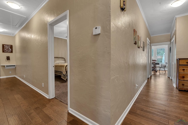 corridor featuring hardwood / wood-style flooring and ornamental molding