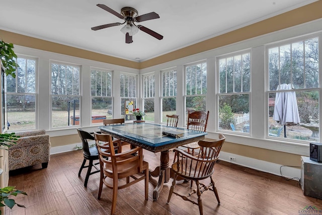 sunroom / solarium with ceiling fan and a healthy amount of sunlight