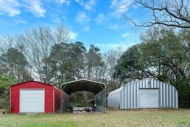 view of outbuilding with a carport, a garage, and a yard