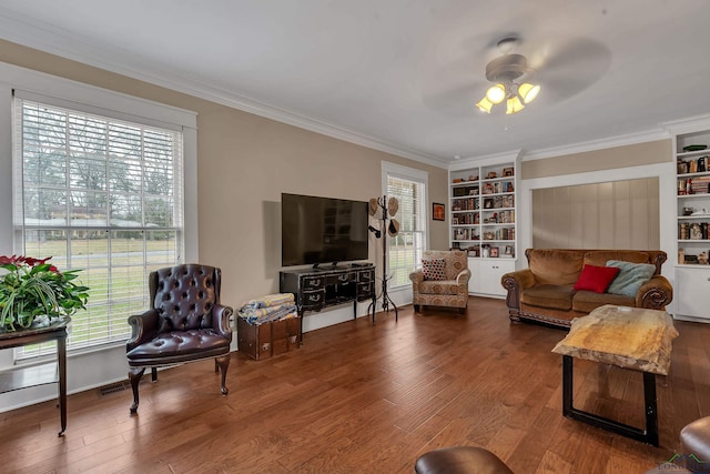 living room with ornamental molding, a wealth of natural light, and hardwood / wood-style floors