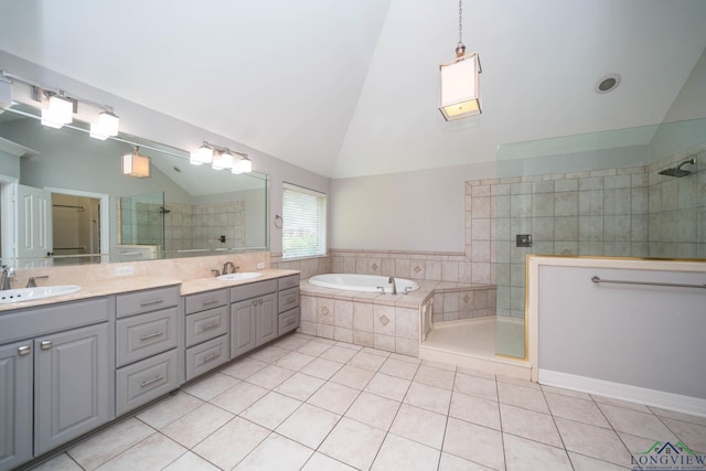 full bathroom with a garden tub, a sink, tile patterned floors, and tiled shower