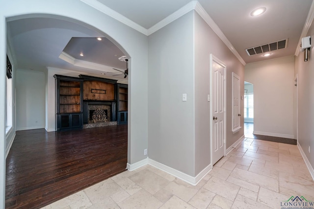 corridor with arched walkways, stone tile floors, recessed lighting, and visible vents