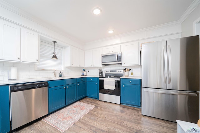 523 Molly Cir, Carthage, TX 75633 - kitchen with appliances with stainless steel finishes, blue cabinets, white cabinetry, ornamental molding, and backsplash