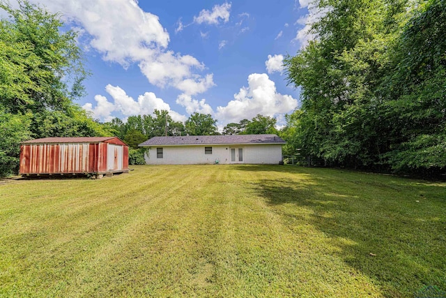 523 Molly Cir, Carthage, TX 75633 - view of grassy yard with a storage shed