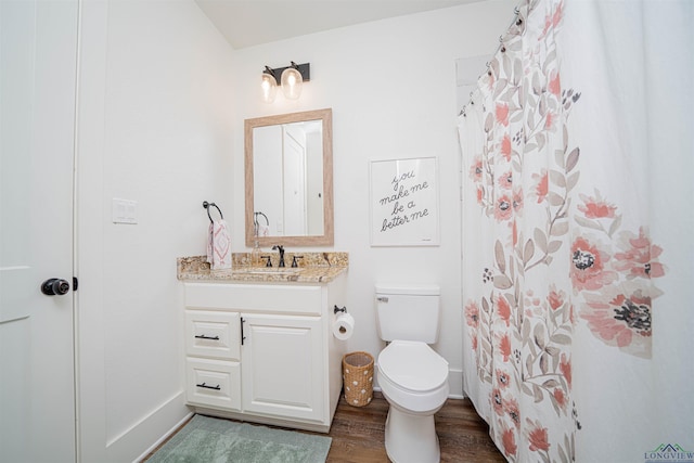 bathroom featuring toilet, a shower with curtain, vanity, and wood finished floors