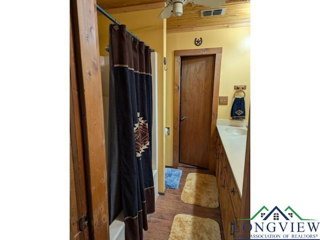 bathroom featuring vanity, hardwood / wood-style flooring, ceiling fan, and shower / bath combo with shower curtain