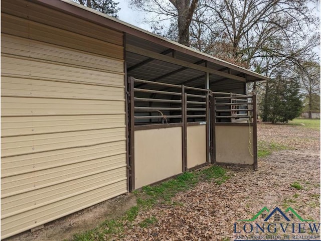 view of side of home featuring an outdoor structure