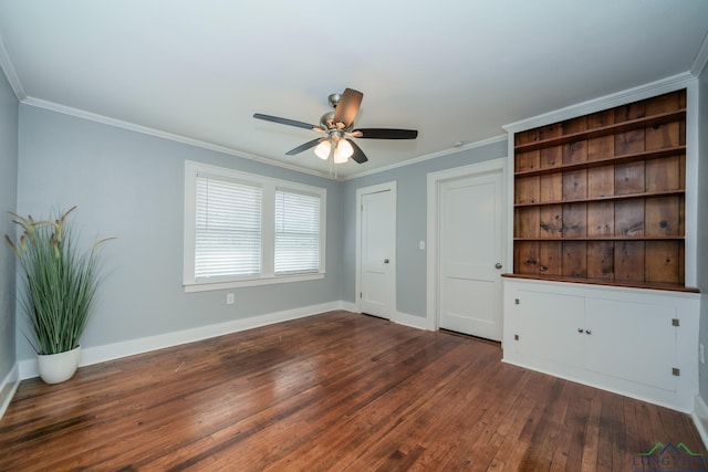 spare room featuring ceiling fan, dark hardwood / wood-style flooring, and crown molding