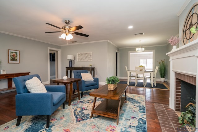 living room with ceiling fan, crown molding, a fireplace, and dark wood-type flooring