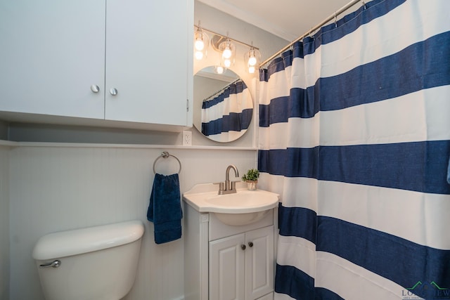 bathroom featuring walk in shower, toilet, vanity, and ornamental molding