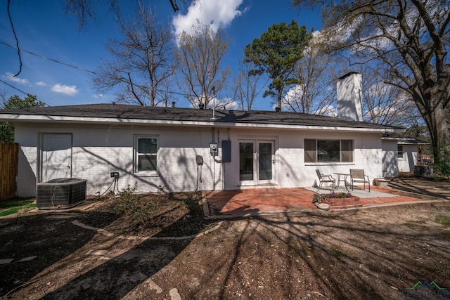 rear view of house featuring central AC unit, a patio, and french doors