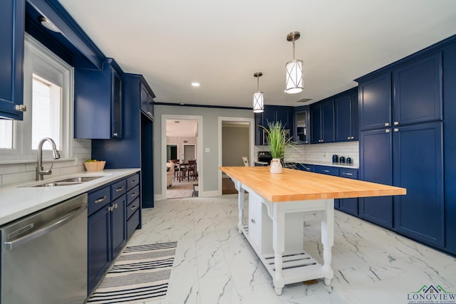 kitchen featuring blue cabinetry, stainless steel dishwasher, butcher block counters, and sink