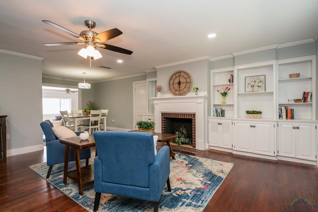 living room featuring a fireplace, dark hardwood / wood-style flooring, ceiling fan, and ornamental molding