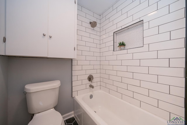 bathroom featuring tile patterned floors, toilet, and tiled shower / bath