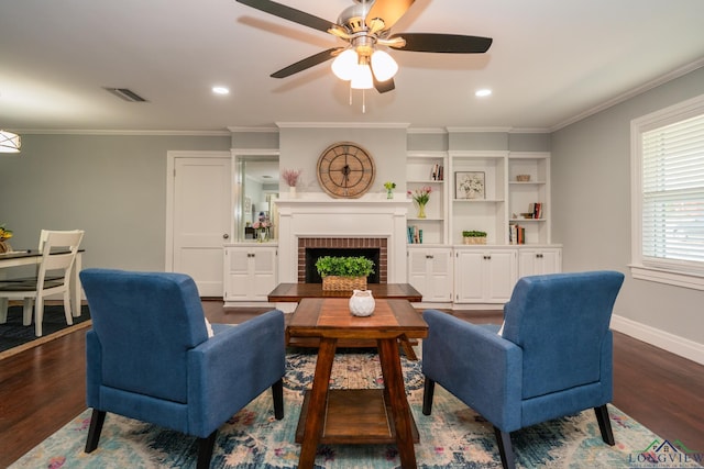 living room featuring dark hardwood / wood-style floors, ceiling fan, ornamental molding, and a brick fireplace