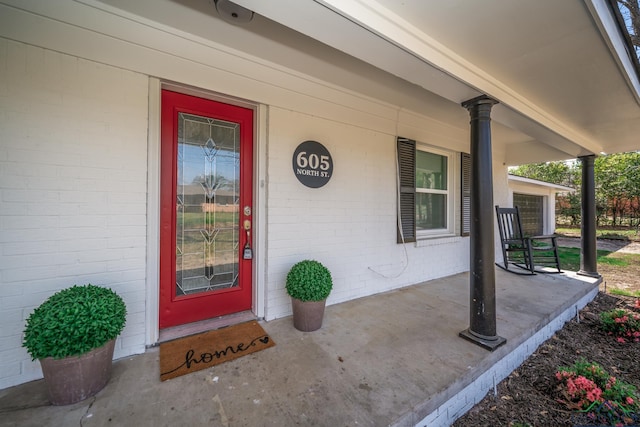 view of exterior entry featuring a porch