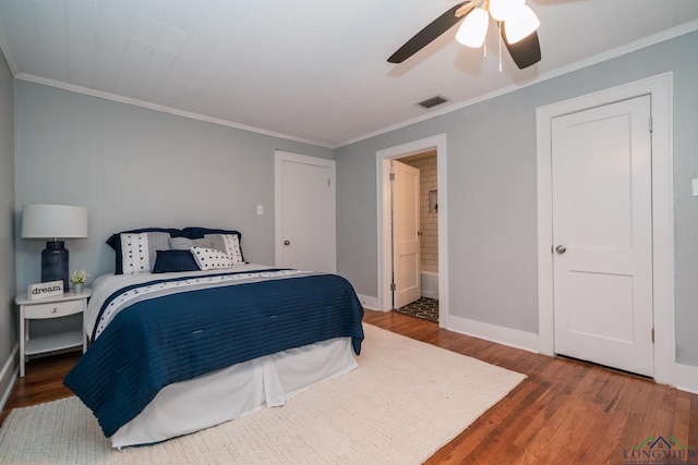 bedroom with ceiling fan, dark wood-type flooring, ensuite bathroom, and ornamental molding