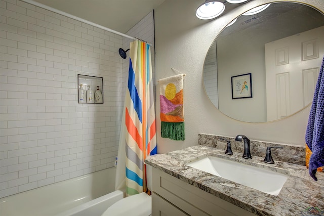 full bath featuring toilet, shower / bath combo, and vanity