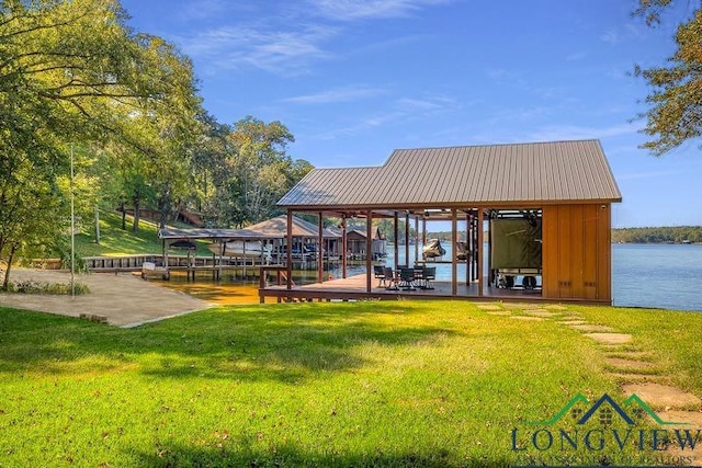 view of community featuring a yard, a boat dock, a water view, and boat lift