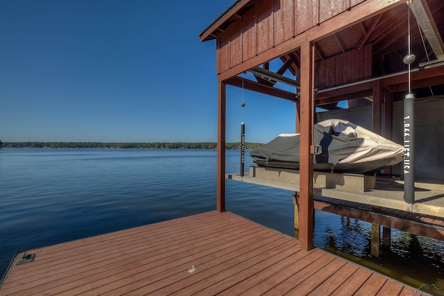 view of dock with boat lift and a water view