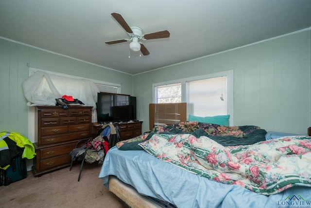 bedroom featuring crown molding, light carpet, and ceiling fan